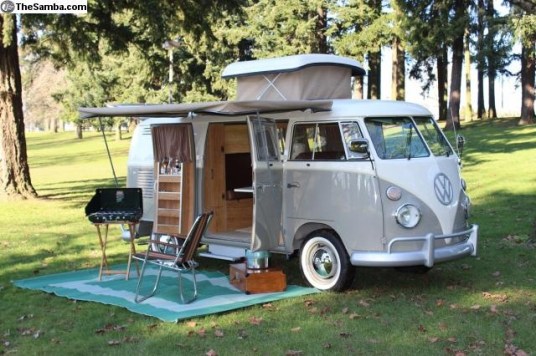 A split bus camper with the early pop-top roof.